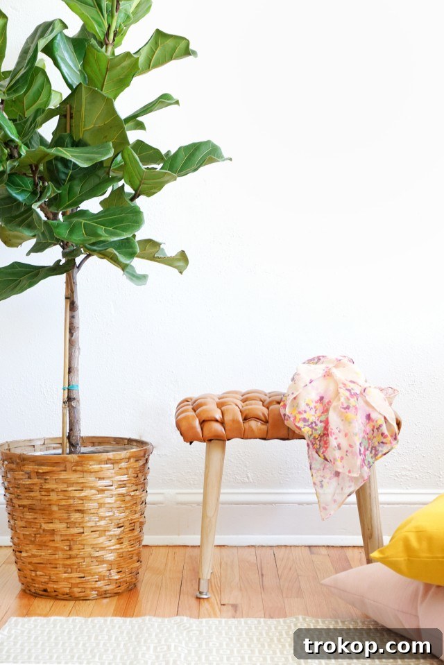 Completed DIY Woven Leather Stool in a stylish setting
