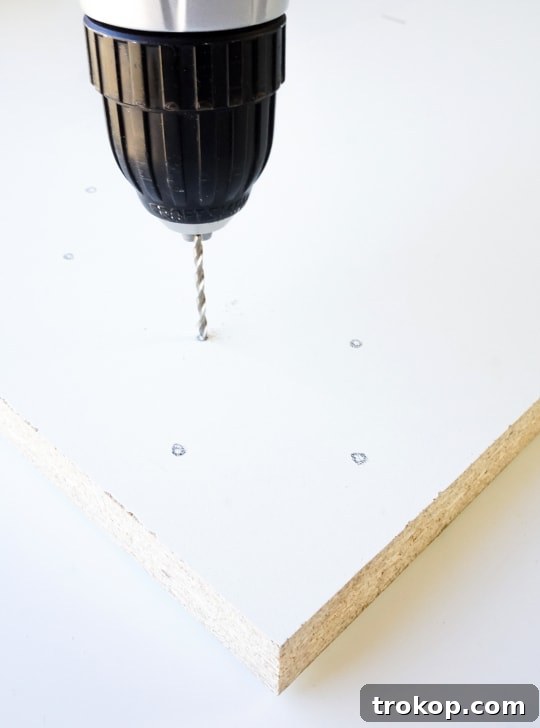 Close-up of sewing machine stitching leather cording