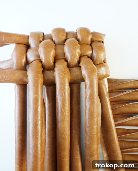 Stapling leather strips to the underside of the stool