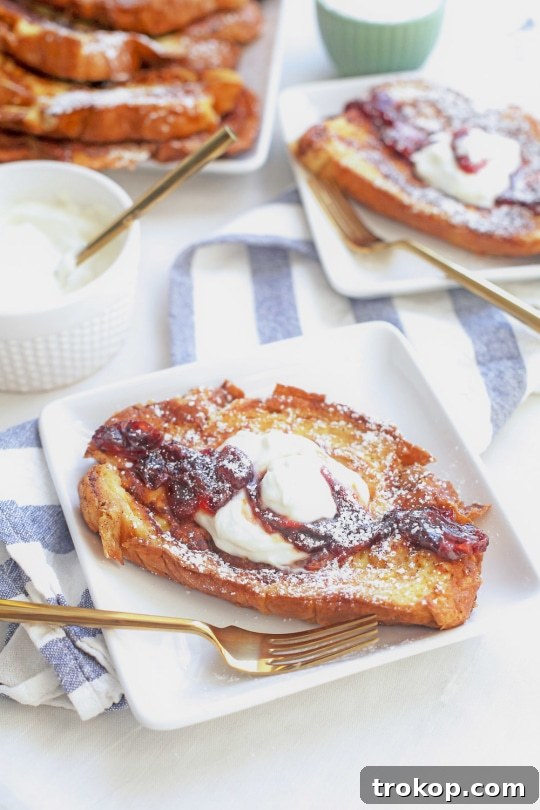 Whipped Ricotta French Toast with Boozy Blood Orange Compote 3 Close-up of fluffy whipped ricotta cheese delicately placed on a stack of French toast.