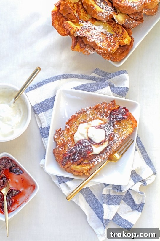 Whipped Ricotta French Toast with Boozy Blood Orange Compote 6 Overhead shot of a plate of French toast, abundant with toppings.