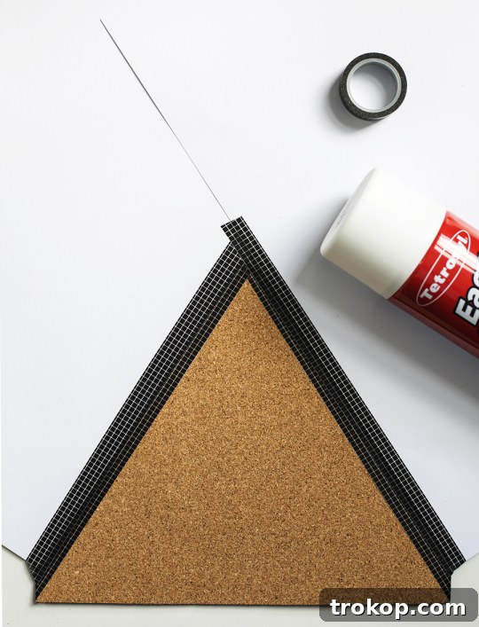Craft Your Custom Desk Organizer 8 Measuring and cutting the self-adhesive cork sheet with a scalpel and ruler for the DIY desk organizer.