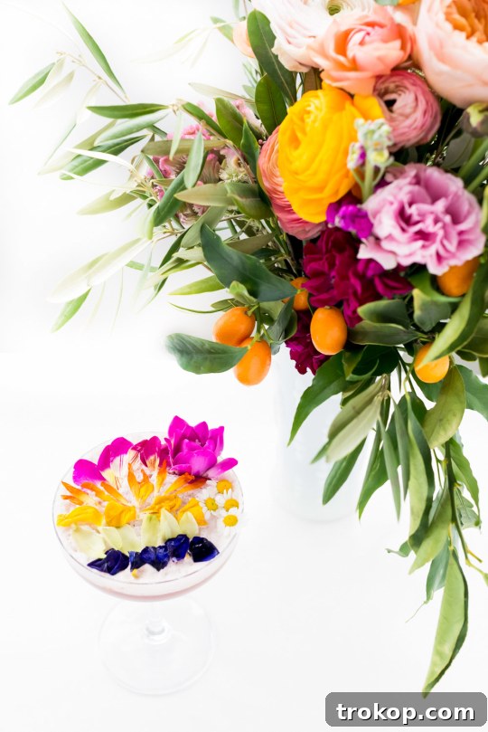 Pink Gin Sour Perfection with Handmade Grenadine 6 Edible flowers with a vibrant cocktail
