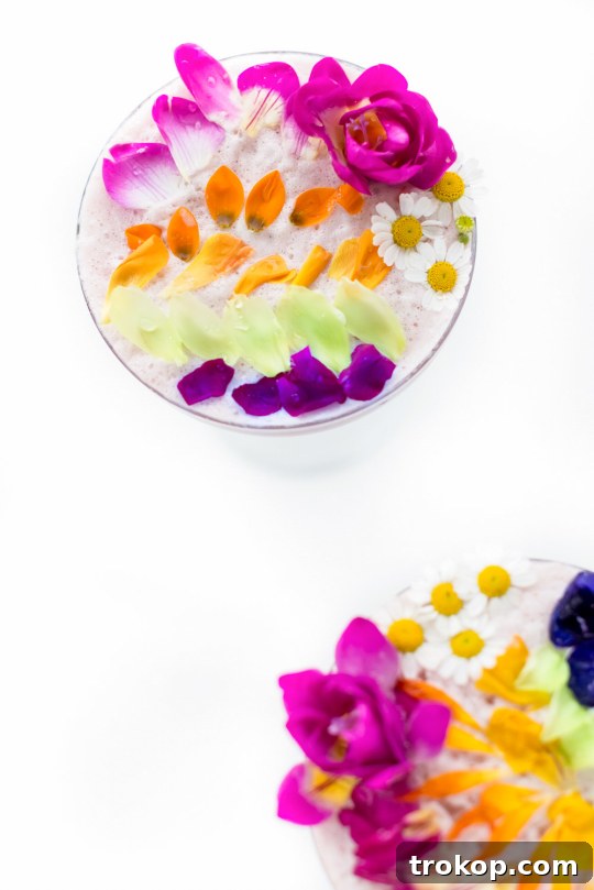 Pink Gin Sour Perfection with Handmade Grenadine 7 Perfectly garnished pink cocktail with colorful edible flowers