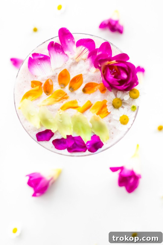 Pink Gin Sour Perfection with Handmade Grenadine 8 Top view of a cocktail with colorful edible petals