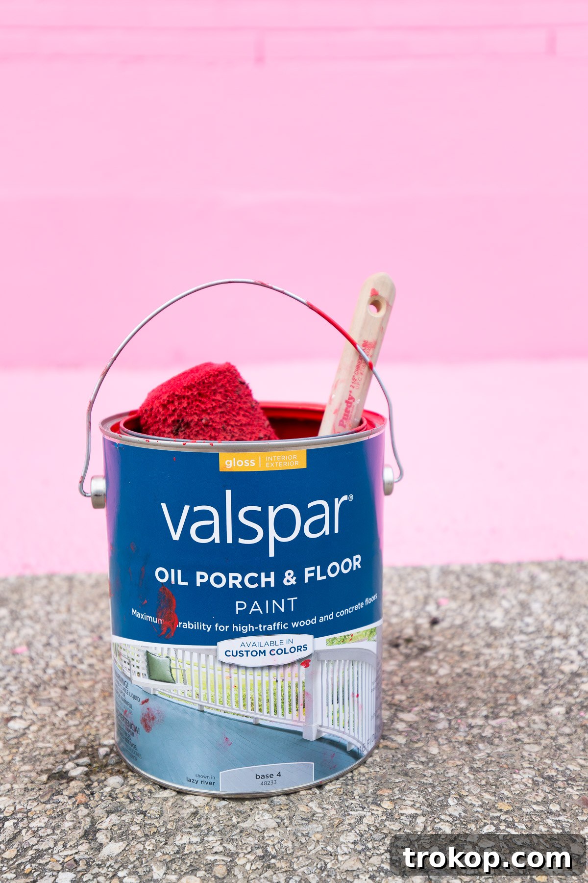 Applying Valspar paint to the Sugar and Cloth mural, ensuring vibrant results.