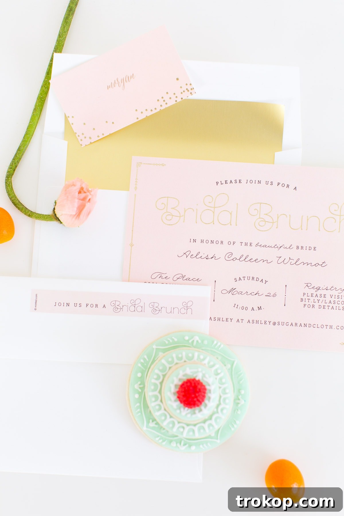 Beautifully arranged spring bridal shower table setting with personalized gilded place cards.