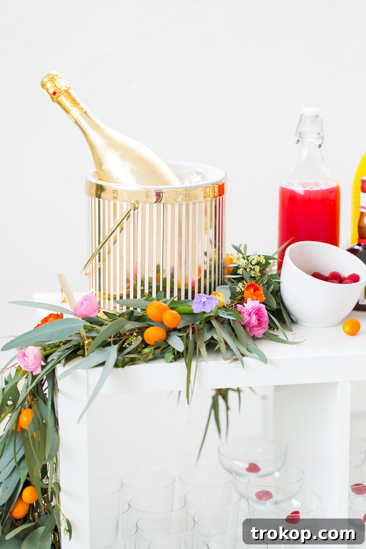 Ingredients for a custom mimosa cocktail, including Grand Marnier and fresh garnishes.