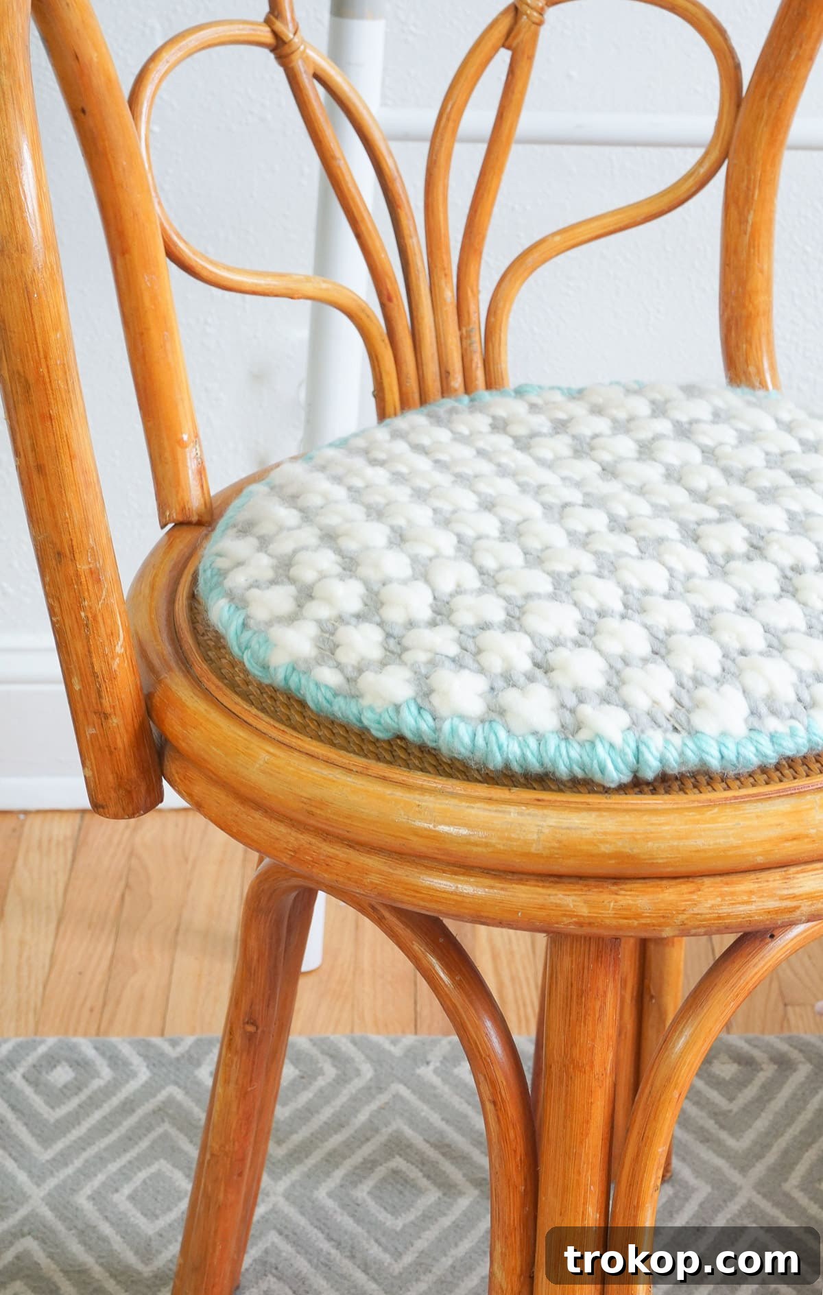 Artisan Oversized Cross-Stitch Pillow 11 Detail shot of the modern oversized cross-stitched cushion, highlighting the intricate pattern and soft yarn.