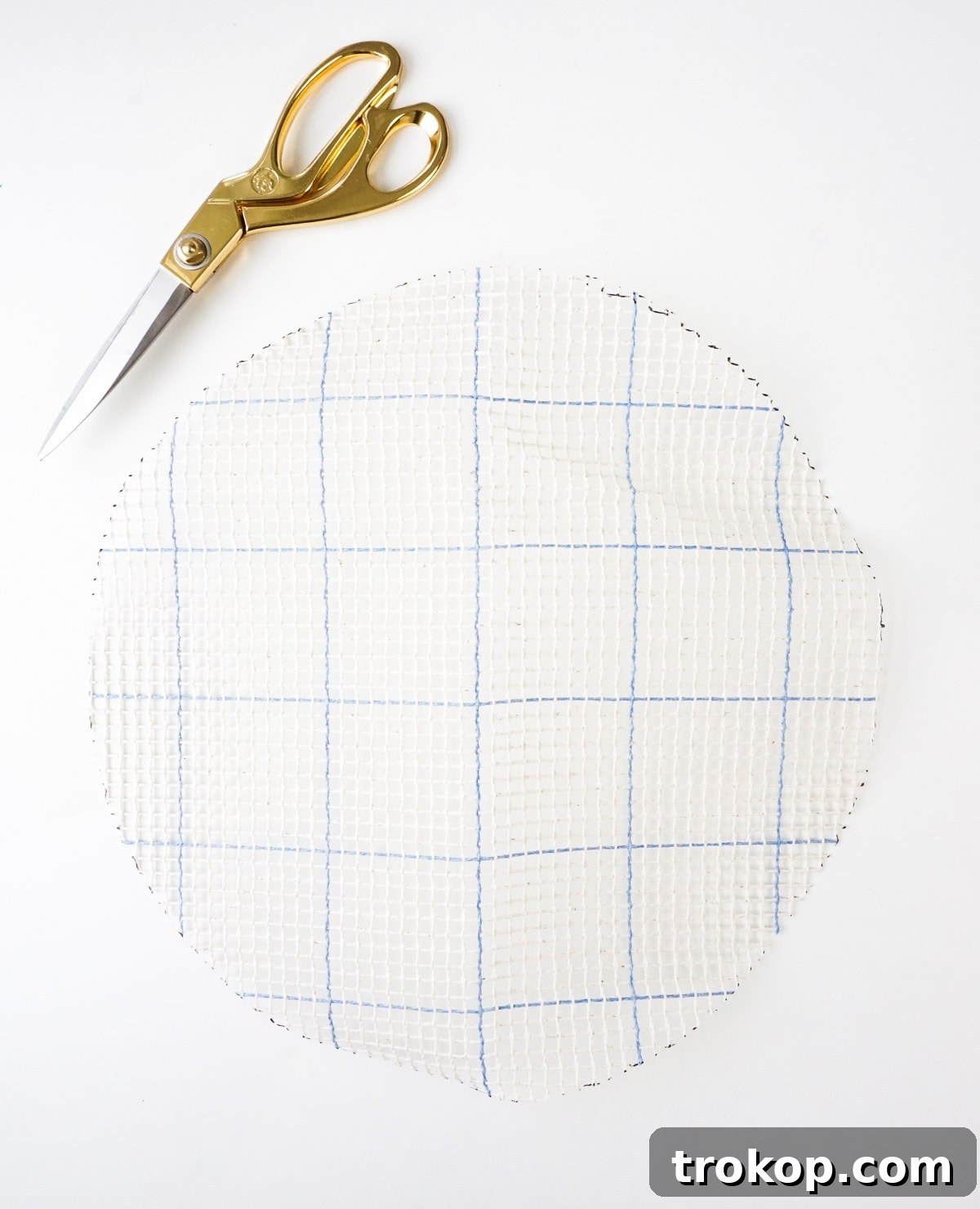 Artisan Oversized Cross-Stitch Pillow 4 A close-up view of the graph n' latch rug canvas with chunky yarn and a plastic needle, ready for an oversized cross-stitch project.