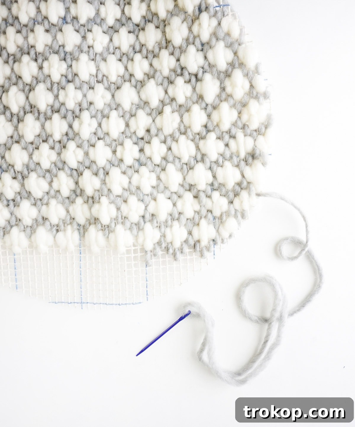 Artisan Oversized Cross-Stitch Pillow 7 A completed oversized cross-stitch panel in ivory, grey, and mint, showcasing the intricate texture and pattern.