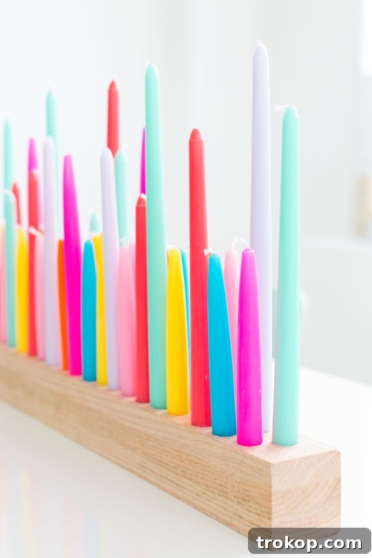 A beautifully decorated table setting featuring a rainbow DIY taper candle holder as the centerpiece