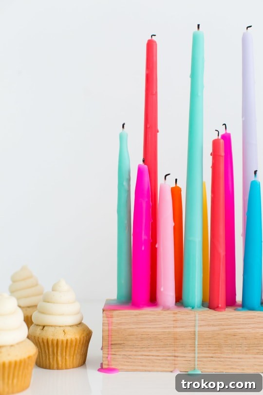 A rainbow DIY taper candle holder casting a warm, inviting glow in a room setting