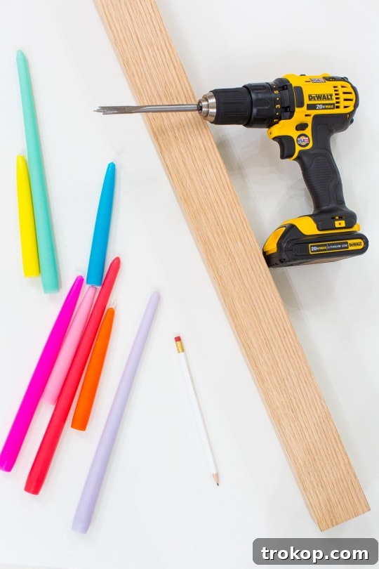 An overhead shot of a vibrant DIY candle holder, showcasing colorful taper candles arranged artfully