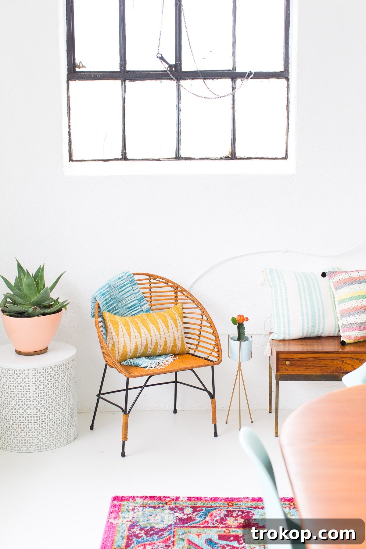 Dining room corner with stylish blue chairs and framed artwork
