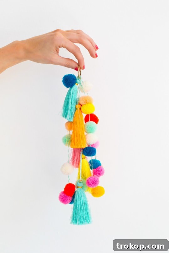 The completed DIY pom pom tassel circle bag, beautifully embellished and ready for summer use.