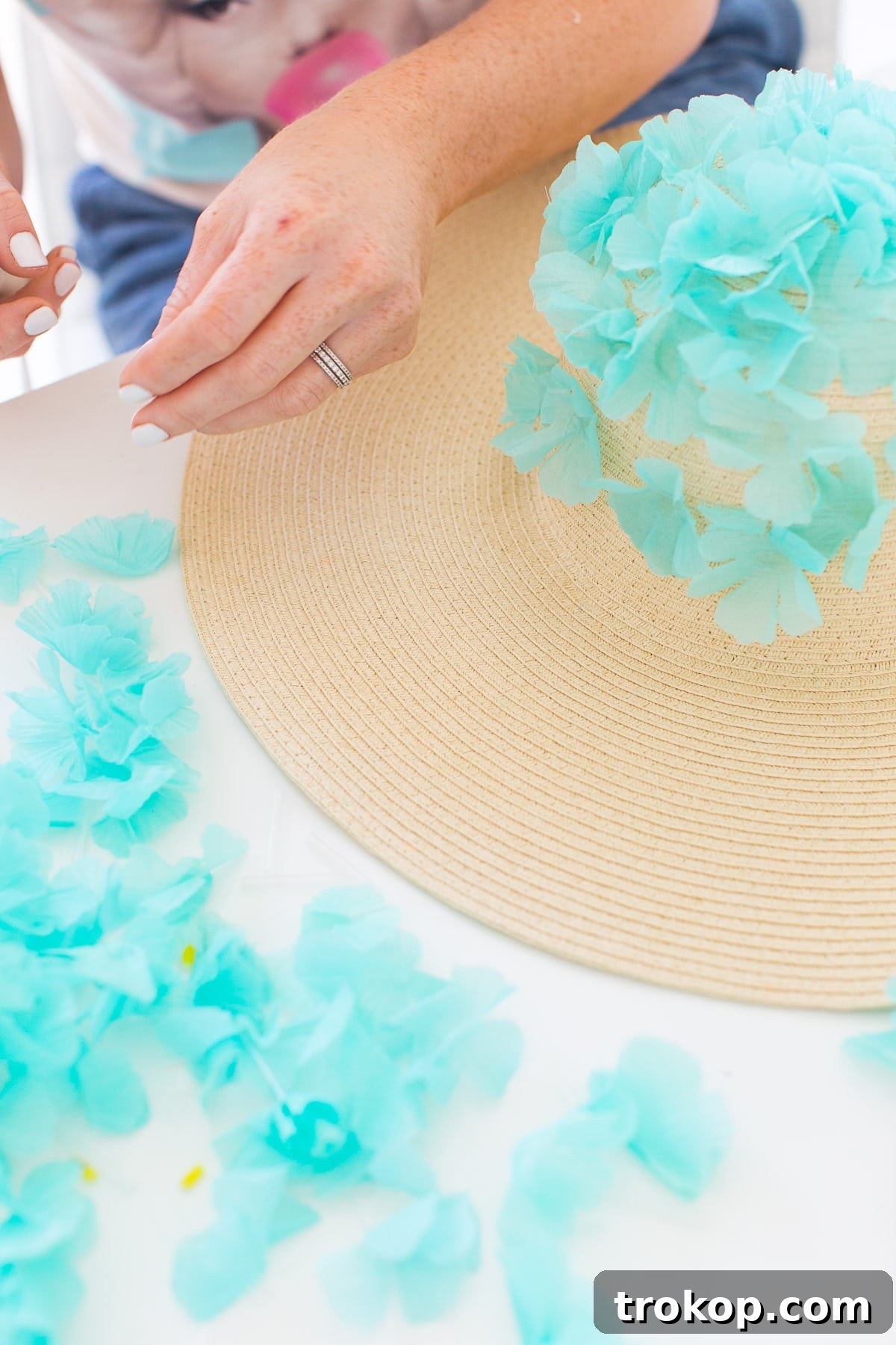 A completed section of the DIY floral floppy hat, showcasing dense and even flower placement.