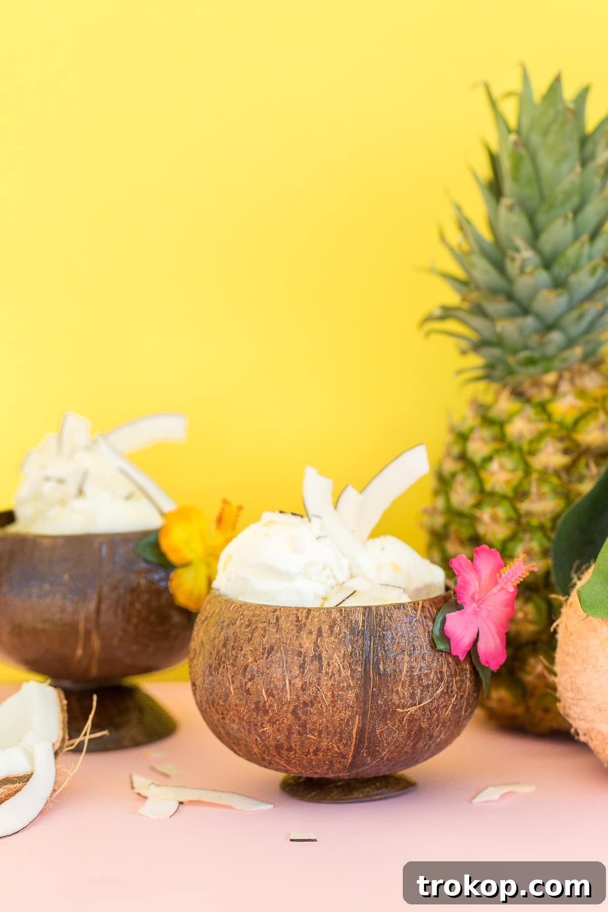 Close-up shot of creamy pineapple coconut ice cream in a small glass, inviting and refreshing.