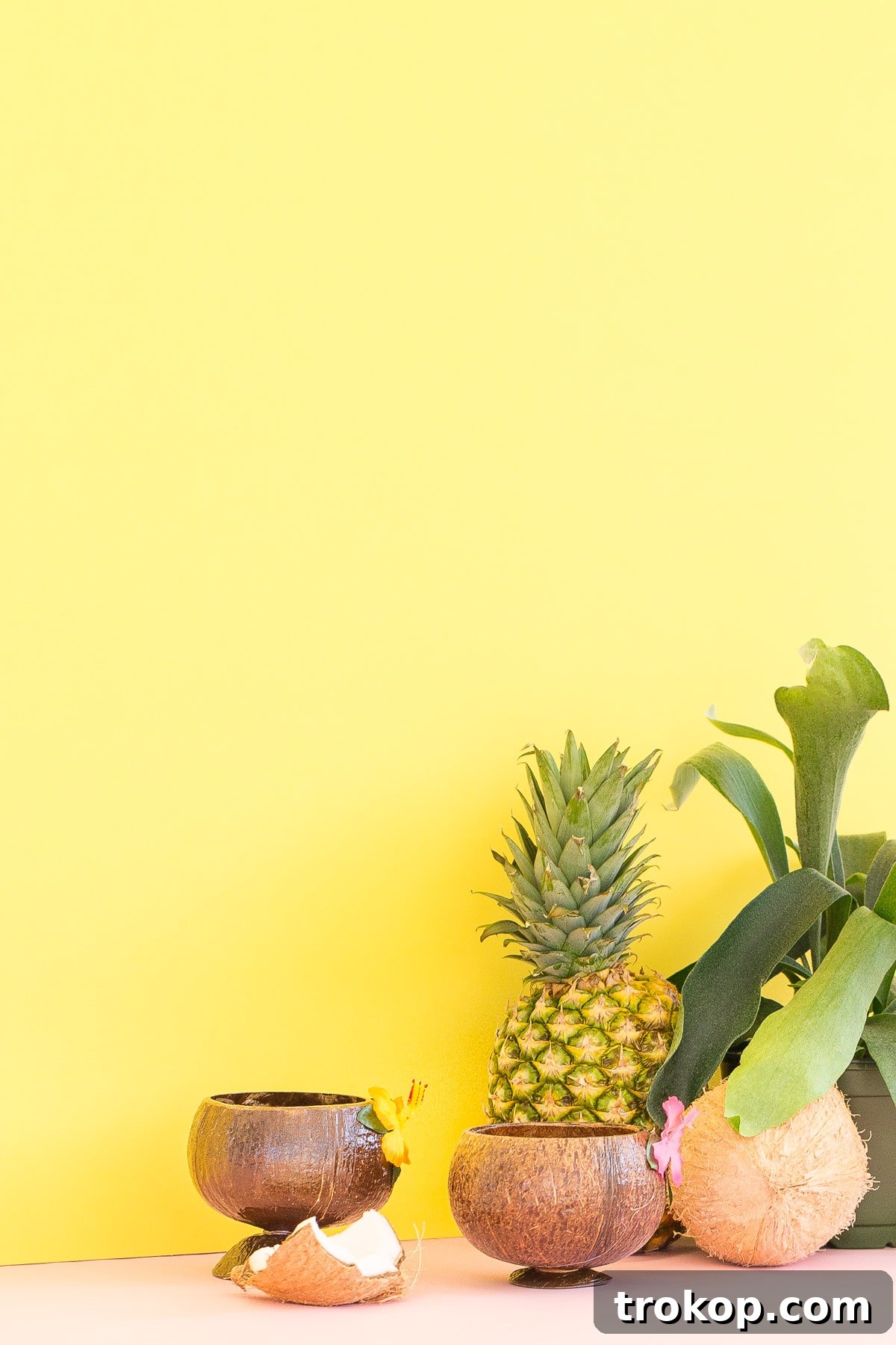 Three small glasses of no-churn pineapple coconut ice cream lined up, showing off the tropical texture.