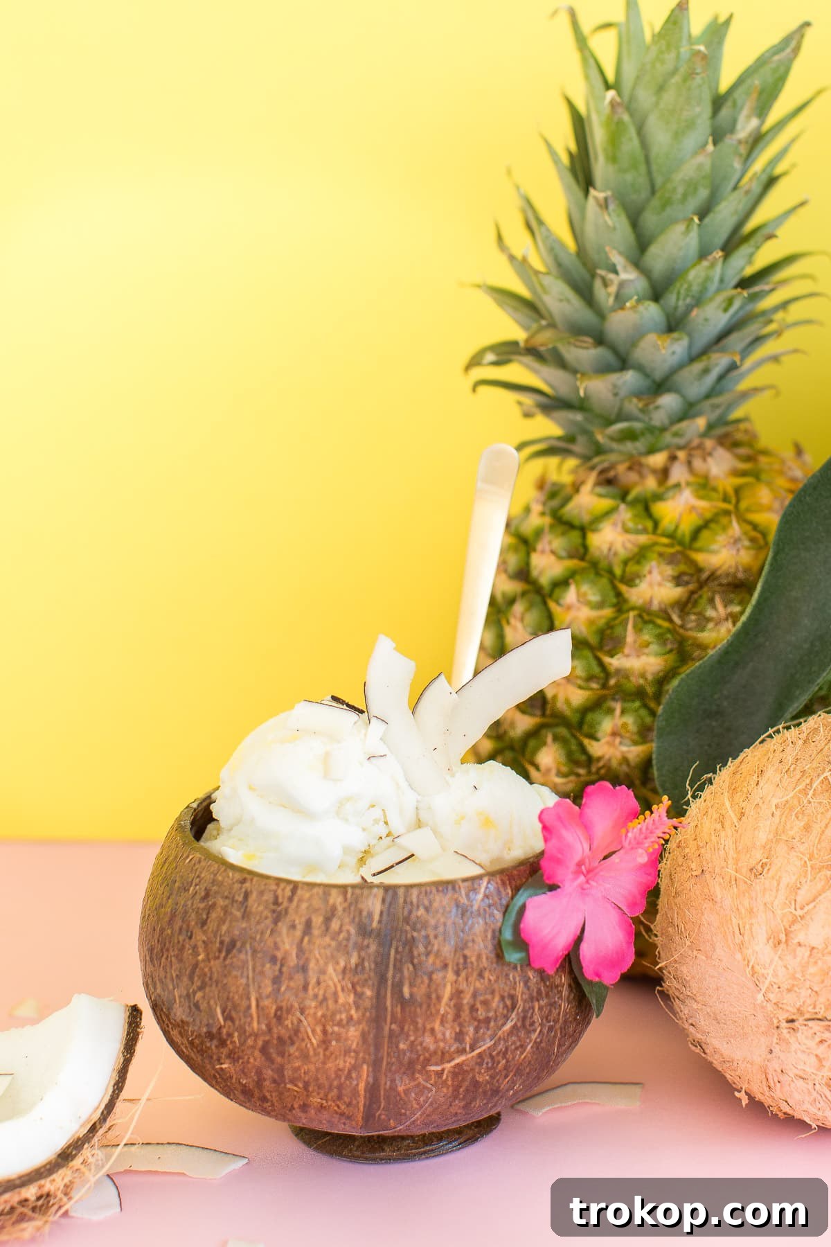 An elegant shot of pineapple coconut ice cream served in footed glass bowls.