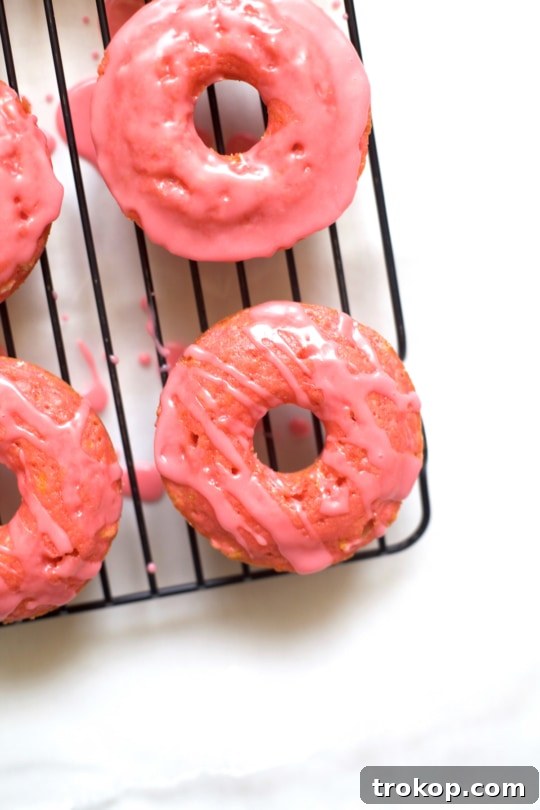 Close-up of baked pink lemonade donuts with a glossy glaze