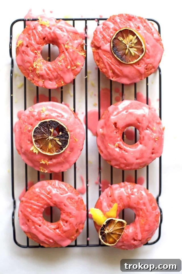 Selection of pink lemonade donuts on a cake stand