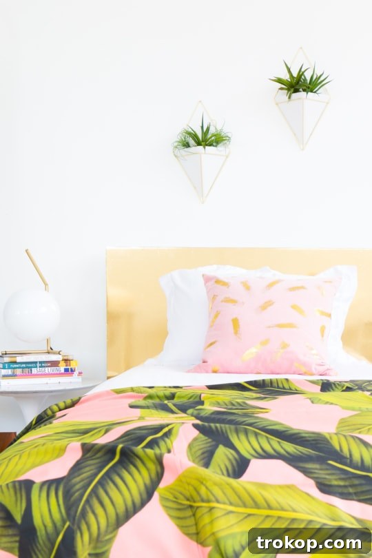 DIY Faux Brass Headboard: Get the High-End Look for Less 8 Glamorous bedroom setup featuring the DIY faux brass headboard, pink rug, and decorative pillows