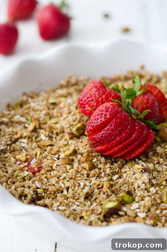 Heavenly Strawberry Pistachio Crumble 4 Close-up of a baked strawberry pistachio crumble, showing the golden crunchy topping.