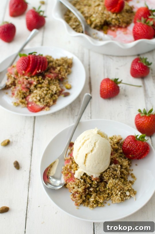 Heavenly Strawberry Pistachio Crumble 5 Various ingredients laid out, including fresh strawberries, butter, and pistachios, for a crumble recipe.