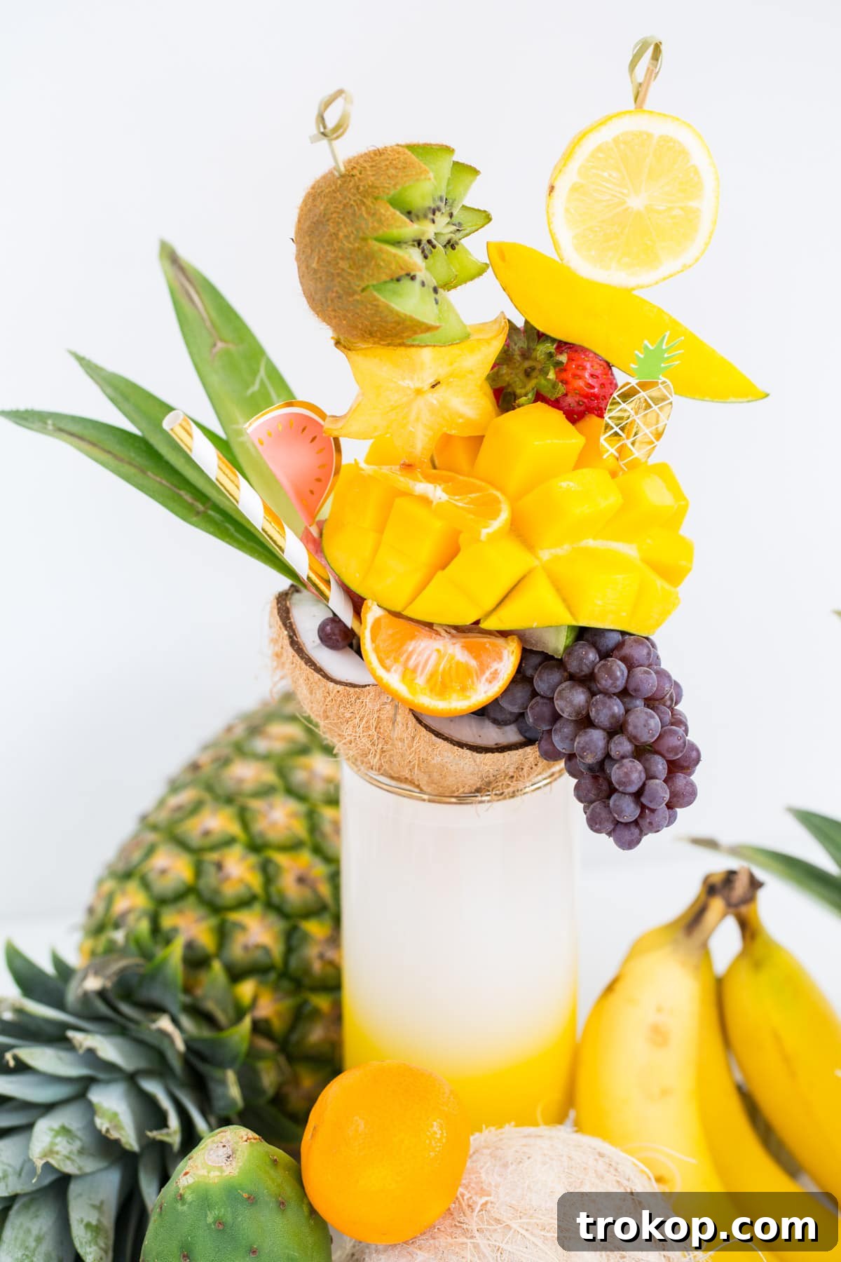 Various stages of assembling a tropical fruit freakshake