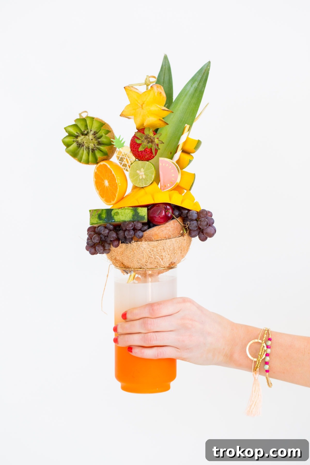 A fruit freakshake nearing completion with many garnishes