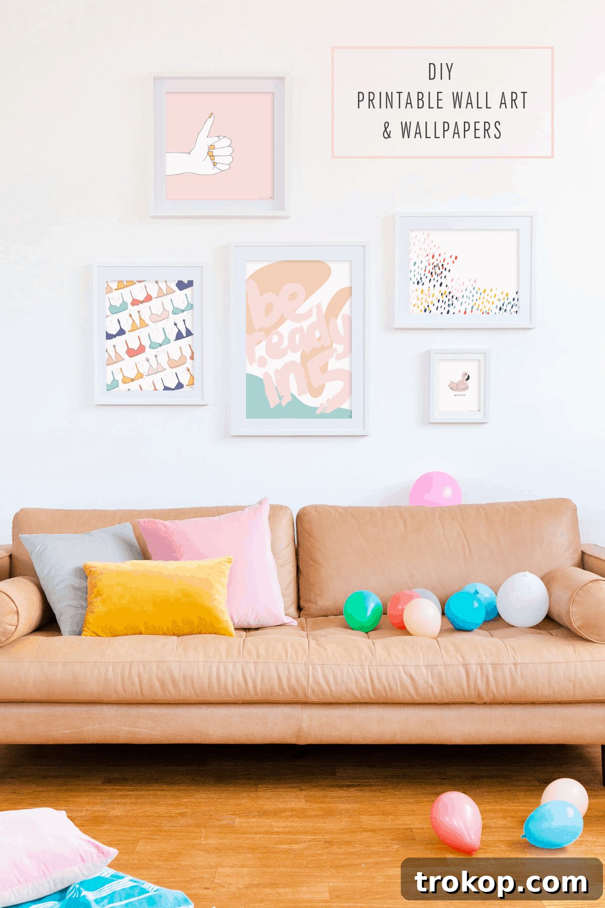 Stylish studio interior featuring a grey leather sofa and vibrant printable art, showcasing modern home decor ideas.