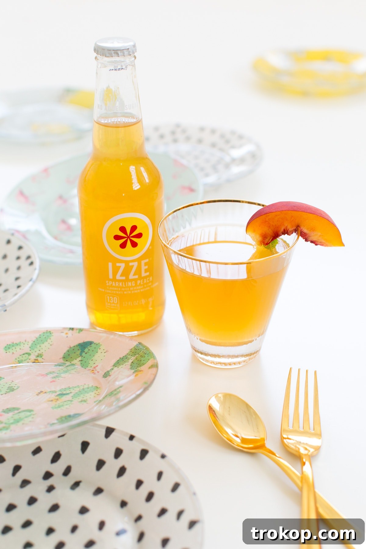 DIY Printed Plates and Peachy-Tini Cocktail 14 A delicious Peachy-Tini cocktail in a martini glass, garnished with fresh mint and a peach slice, served alongside DIY printed plates