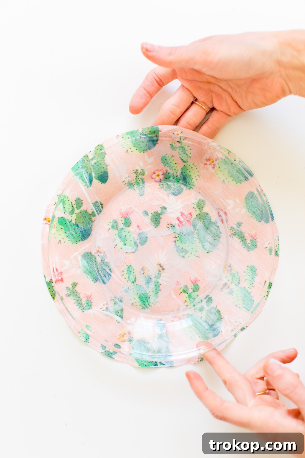 Second step in DIY printed plates: using sharp scissors to cut out the fabric circle, ensuring a clean edge