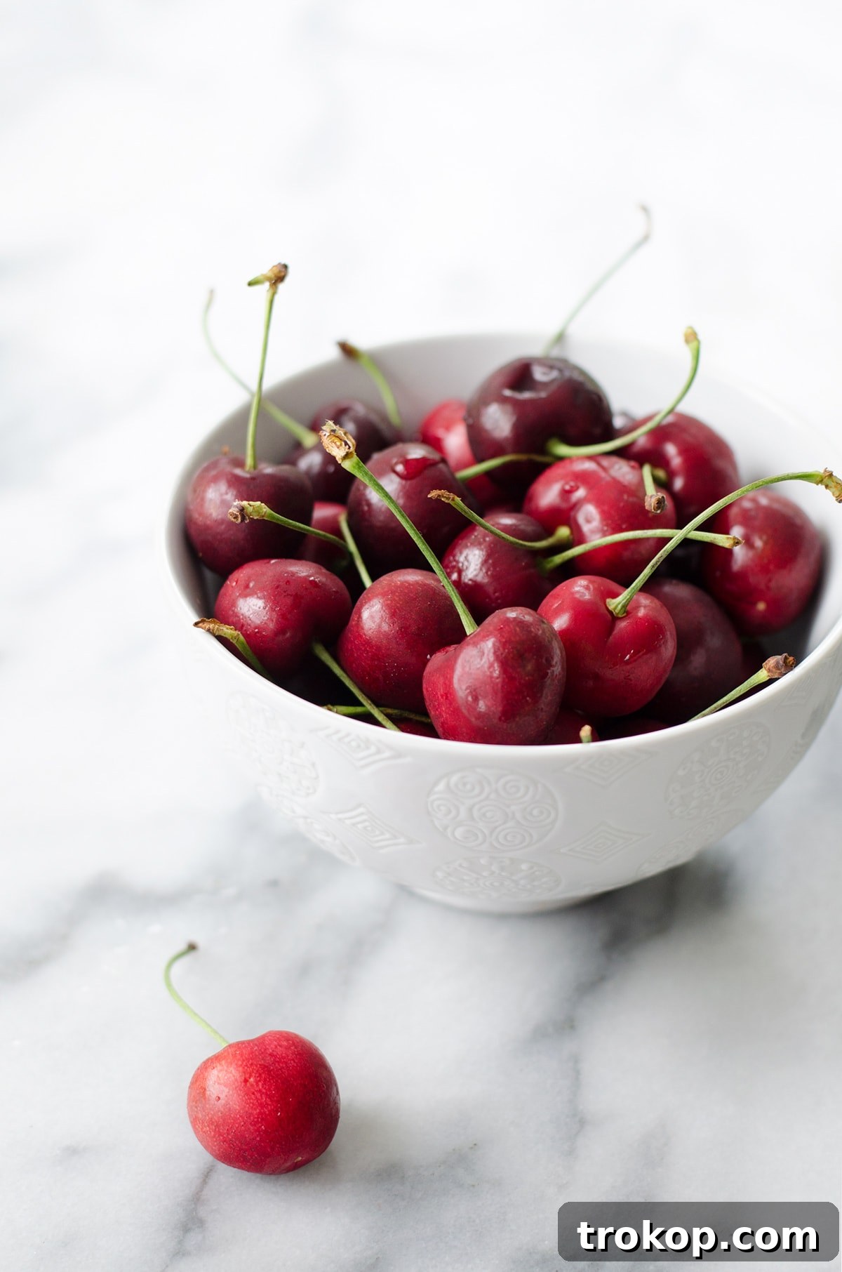 Several homemade Roasted Peach and Cherry Popsicles displayed enticingly, inviting a refreshing bite
