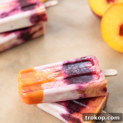Roasted Peach and Cherry Popsicles, a delicious and healthy frozen dessert perfect for summer from Sugar & Cloth
