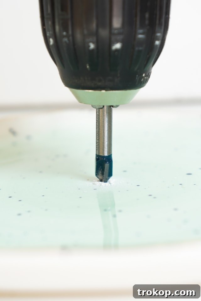 Drilling a hole in a decorative plate for the clock mechanism