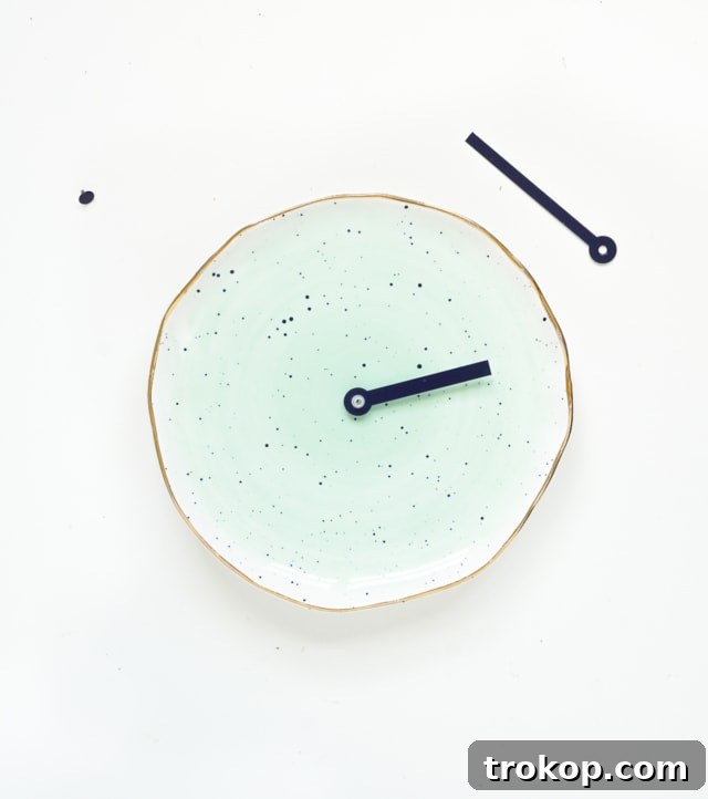 Attaching clock hands to complete the DIY plate clock
