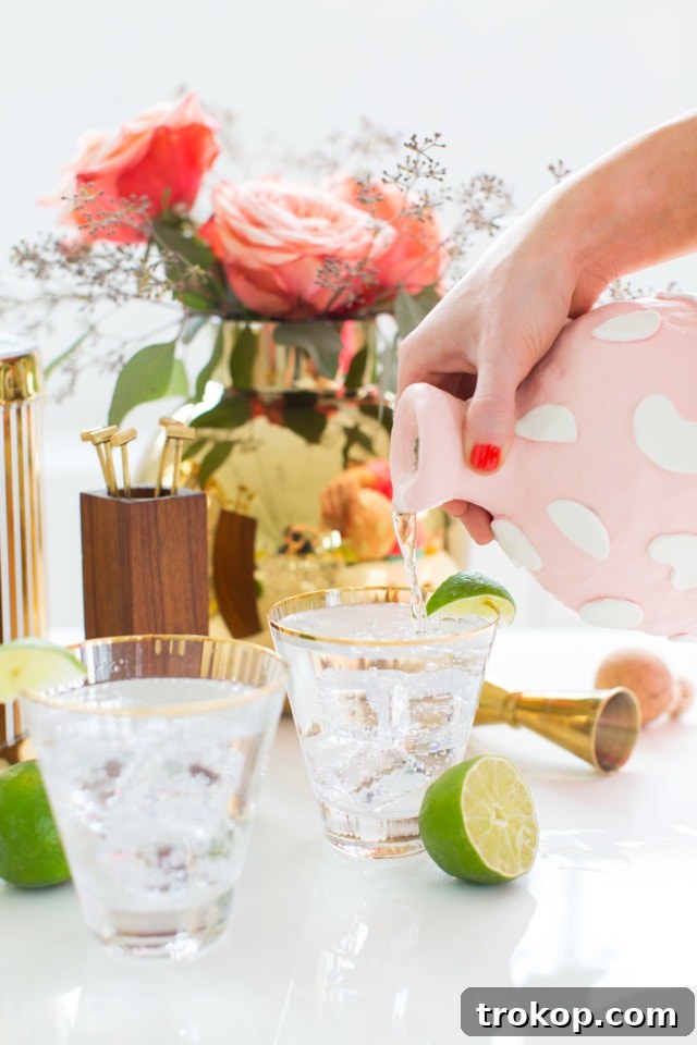 A creatively adorned clay decanter made from an old Patron bottle, showcasing a unique textured finish and intricate designs, perfect for a chic bar cart setup.