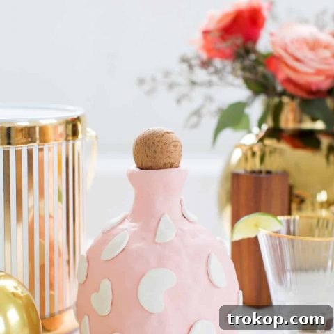 A finished DIY clay decanter with textured surface and decorative shapes, ready for use or display.