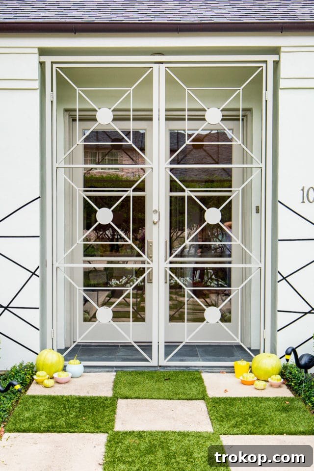 Mid-century metal doors and a checkered entrance, showcasing Palm Springs-inspired Halloween style.