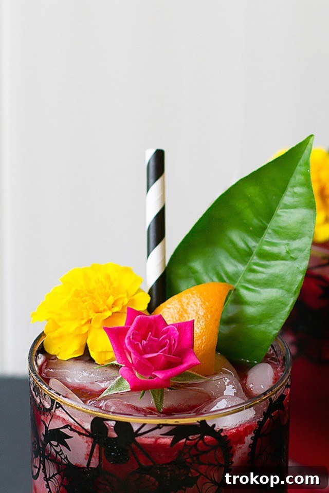 close up for Halloween cocktail ideas with edible flowers by Sugar & Cloth