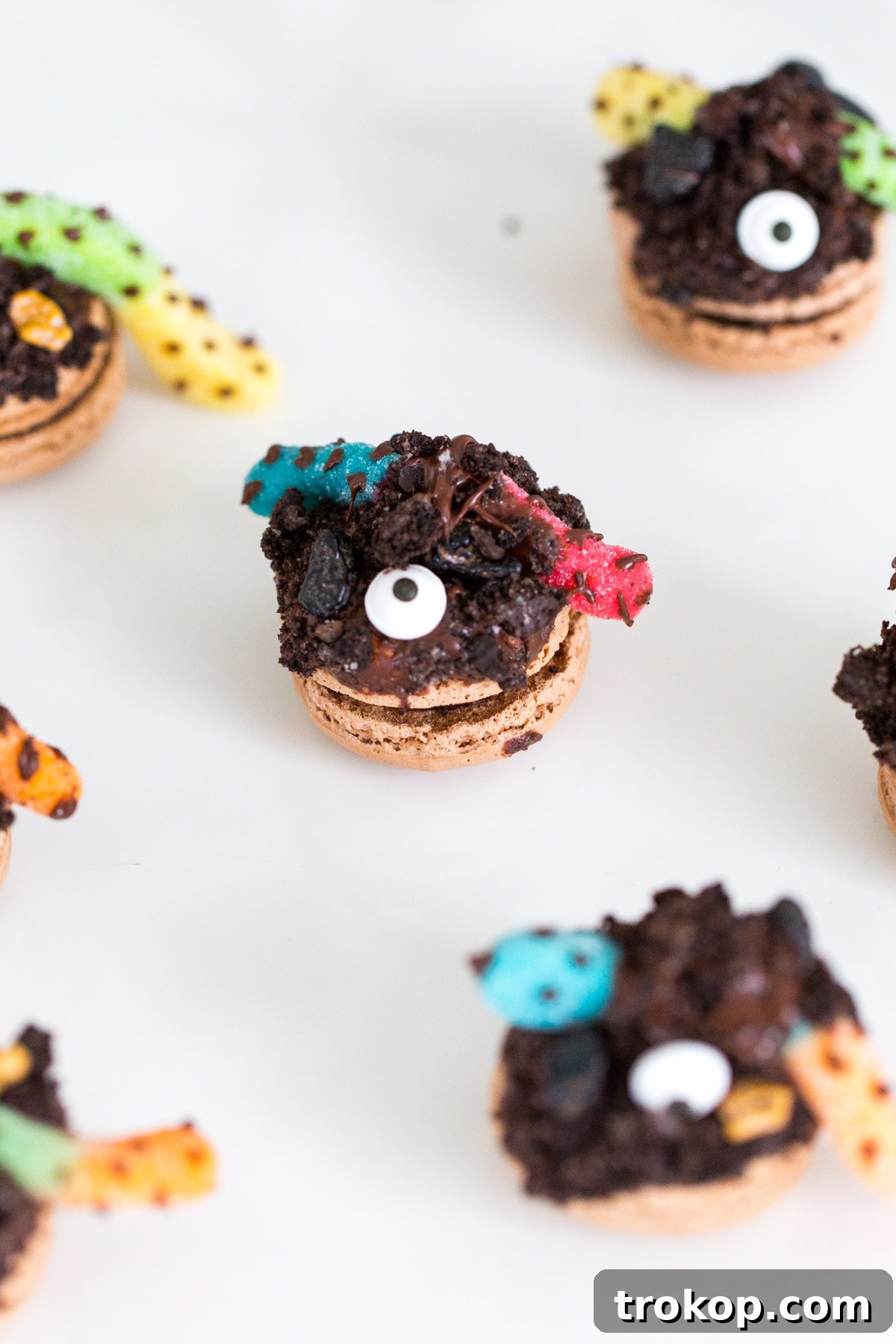 Finished DIY Dirt Worm Macarons with chocolate polka dots on gummy worms.