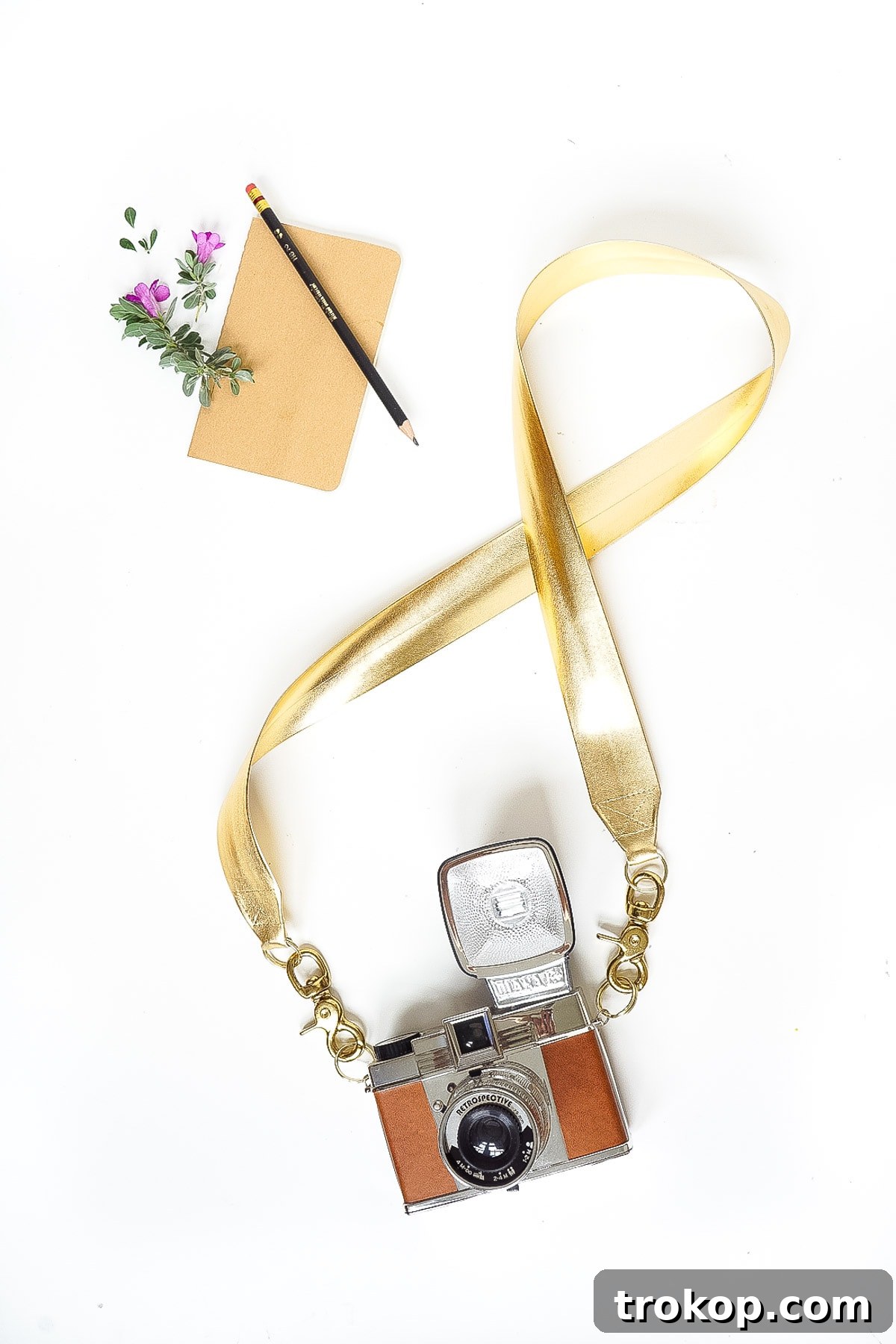 Elevate your photography style with a custom DIY Glam Camera Strap featuring metallic gold trim, perfect for fall travel and stylish adventures.