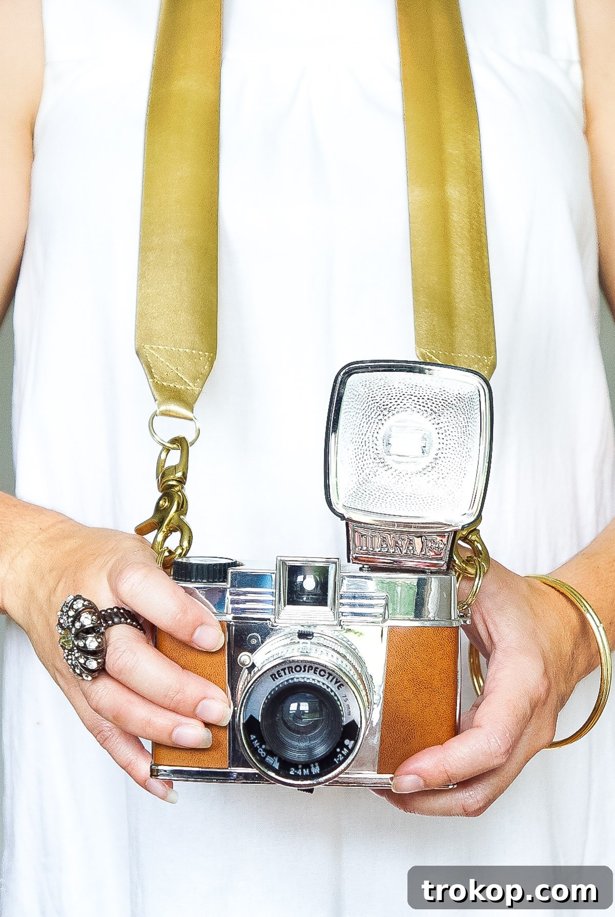Close-up of the elegant metallic gold trim of the DIY Glam Camera Strap, highlighting the quality of the materials and craftsmanship.