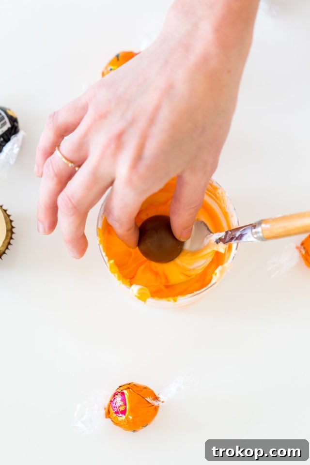 Adorable Truffle Monster Cake Toppers Recipe 7 Adding extra royal icing with a straw to create spiky monster fur