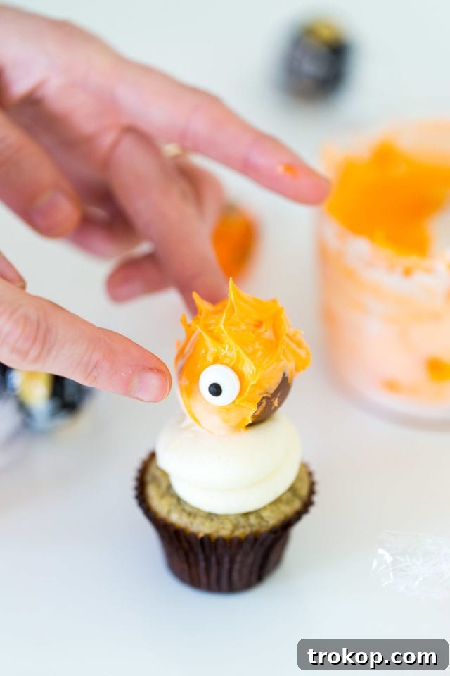 Adorable Truffle Monster Cake Toppers Recipe 9 Collection of finished DIY Truffle Monster Cupcake Toppers on a white platter