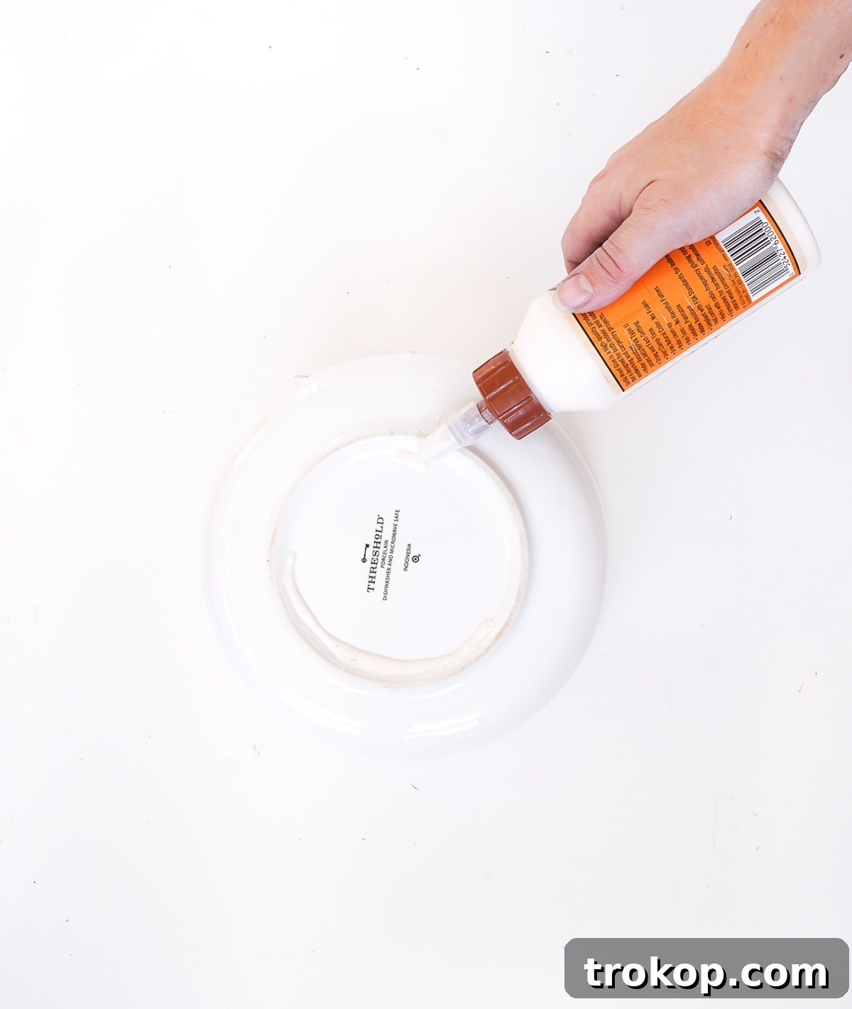 Applying industrial strength glue to the rim of the large bowl, a critical step for creating a sturdy DIY Mid Century Modern Planter.
