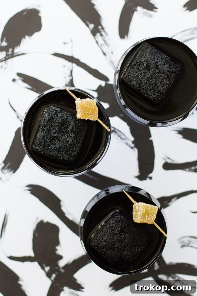 Activated Charcoal Elixirs: Detox Cocktails and Mocktails 7 A collection of gothic or 'creepy' activated charcoal cocktails, perfect for a themed event like Halloween, emphasizing the drink's dramatic dark color.