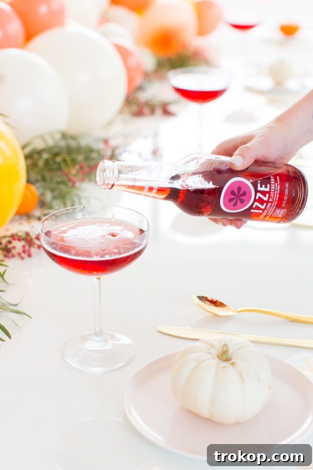Close-up of a refreshing Blackberry Blitz Cocktail, garnished with rosemary